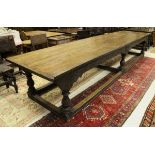 An oak refectory style dining table in the 17th Century manner the four plank top with cleated ends