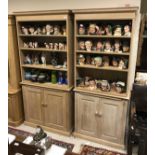 A matched pair of limed oak bookcase cabinets,