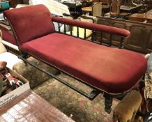 A Victorian oak framed chaise longue and a circa 1900 day bed with floral upholstery