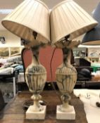 A pair of 19th Century alabaster urn shaped table lamps with foliate castellated rims