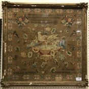 A mid-19th Century needlework depicting birds on a bath,