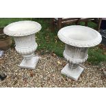 A pair of modern composite stone garden urns of typical form, the insides stamped "H. G. C.