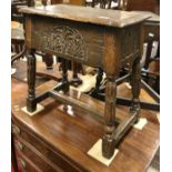 A 17th Century style oak boxed seat stool with single piece top and moulded edge over slightly