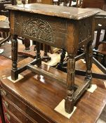 A 17th Century style oak boxed seat stool with single piece top and moulded edge over slightly