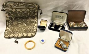 A box containing various collar studs,