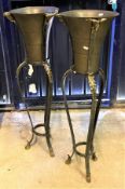 A pair of modern brass trumpet shaped wine coolers on wrought iron and brass embellished stands in