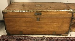 A 19th Century camphor wood trunk with brass corners and embellishments