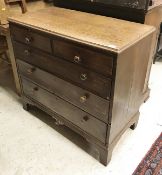 A 19th century oak chest of two short over three long drawers to bracket feet