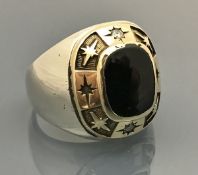 An American 14 carat gold white metal onyx and diamond set college ring