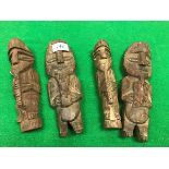 A collection of four Inca type carved wooden totems