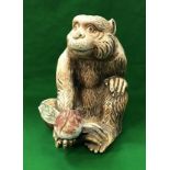 A Japanese Meiji period porcelain figure of a monkey with peach