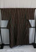 A circa 1960 wool kimono with Shima (stripe) decoration on a black ground