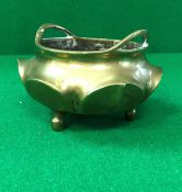 A Chinese bronze censer of small proportions with lotus leaf design raised on three plain feet