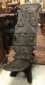 An African carved hardwood seat with figural decoration initialled verso "MT"