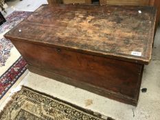 A Victorian stained pine trunk with wrought iron side carrying handles