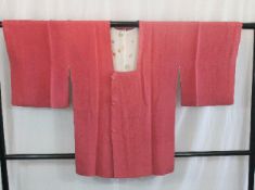 A circa 1960 silk haori (jacket) and obi with Chirimen decoration on a pink ground