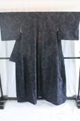 A circa 1960 semi-formal yuki silk kimono with Sharin (Wheel) design on a dark blue ground