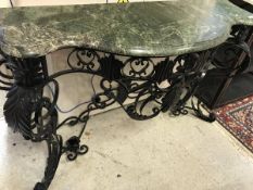 A wrought iron console table in the Rococo style black painted with green marble top