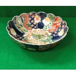 A Chinese Imari bowl of lobed form with polychrome decorated panels,
