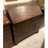 A late George III mahogany bureau with sloping fall enclosing a fitted interior over four long