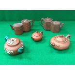 A collection of five Chinese Yi Xing teapots including a double chambered example with reeded