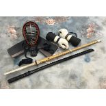 A late 20th Century kendo mask and pair of gloves and two practice shinai