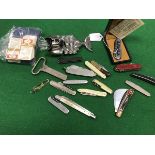 A collection of twelve pocket knives together with a Wenger penknife,