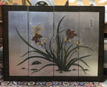 A set of four Chinese lacquered panels decorated with water flowers on a silver background bearing