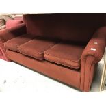 A modern red upholstered scroll arm three seat sofa bed