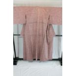 A circa 1960 Tumugi silk semi-formal Hitoe Komon kimono with Hana (flower) pattern on a pink ground