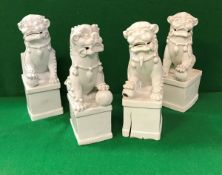 A collection of four 19th Century Chinese blanc-de-chine figues of temple lions,