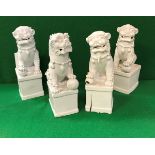 A collection of four 19th Century Chinese blanc-de-chine figues of temple lions,