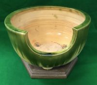 A circa 1900 Japanese oribe ceramic furo with green and yellow glazes on wooden plinth base