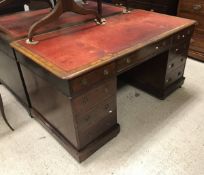 A late Victorian mahogany kneehole desk,