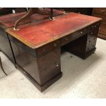 A late Victorian mahogany kneehole desk,