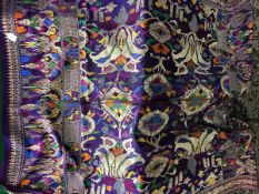 A pair of early 20th Century Indian purple dyed silk table covers with all over decoration in gold