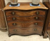 A late George III mahogany serpentine fronted chest of four long graduated drawers on bracket feet