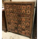 An Oriental elm chest of forty-five drawers each with script embellished paper labels and ring