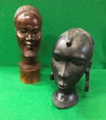 A 20th Century African carved ebony bust of a woman and a carved hardwood bust of a bearded