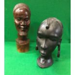 A 20th Century African carved ebony bust of a woman and a carved hardwood bust of a bearded