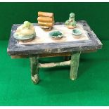 A Chinese Ming Dynasty model of an altar table with green and brown glazed models of offerings