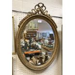 A gilt framed oval mirror with ribbon decoration together with a further oval gilt framed mirror