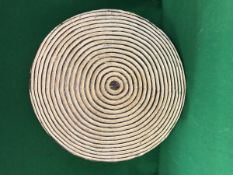 A carved South African Zulu painted treen ware shield with concentric circle decoration bearing