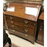 A George III mahogany bureau with sloping fall above four long graduated drawers to bracket feet