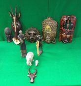 A box containing various Indonesian, African and other carvings including masks, antelope,