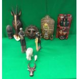 A box containing various Indonesian, African and other carvings including masks, antelope,