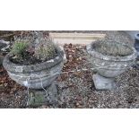 Two reconstituted stone planters on figural decorated plinth bases