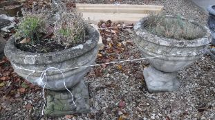 Two reconstituted stone planters on figural decorated plinth bases