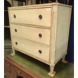 A painted commode chest of three drawers in the Louis XVIth manner