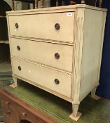 A painted commode chest of three drawers in the Louis XVIth manner